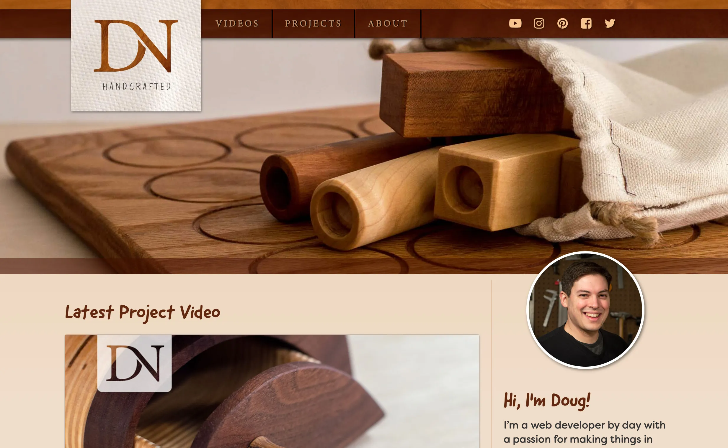 Screenshot of dnhandcrafted.com design which features a close-up of a woodworking project and has warm wood tones for colors.